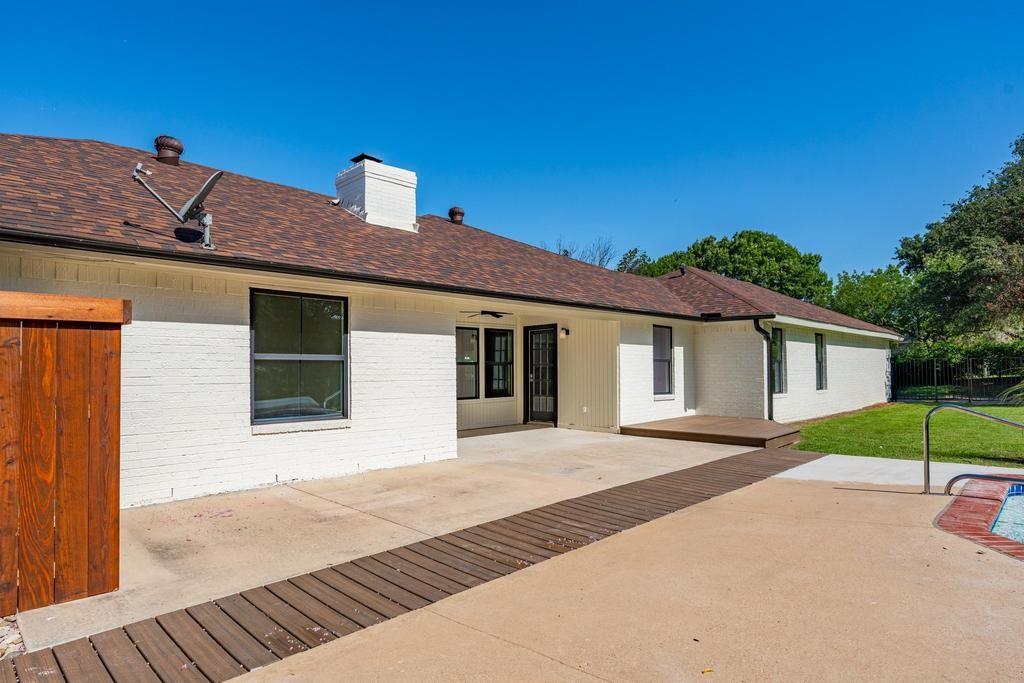 4501 Ridgeway Road Fort Worth, TX 76126 - Photo 29 of 39 a front view of a house with a yard and garage