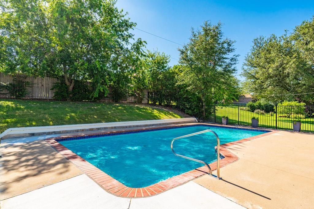 4501 Ridgeway Road Fort Worth, TX 76126 - Photo 30 of 39 a view of a swimming pool and trees in the background