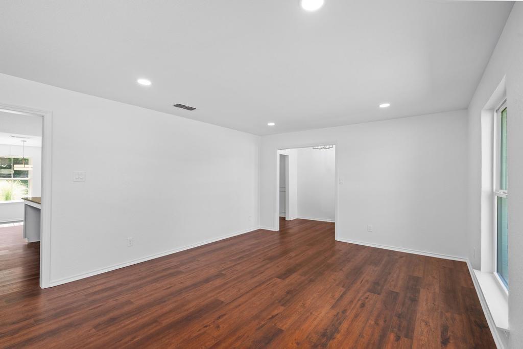 4501 Ridgeway Road Fort Worth, TX 76126 - Photo 9 of 39 a view of an empty room with wooden floor and a window