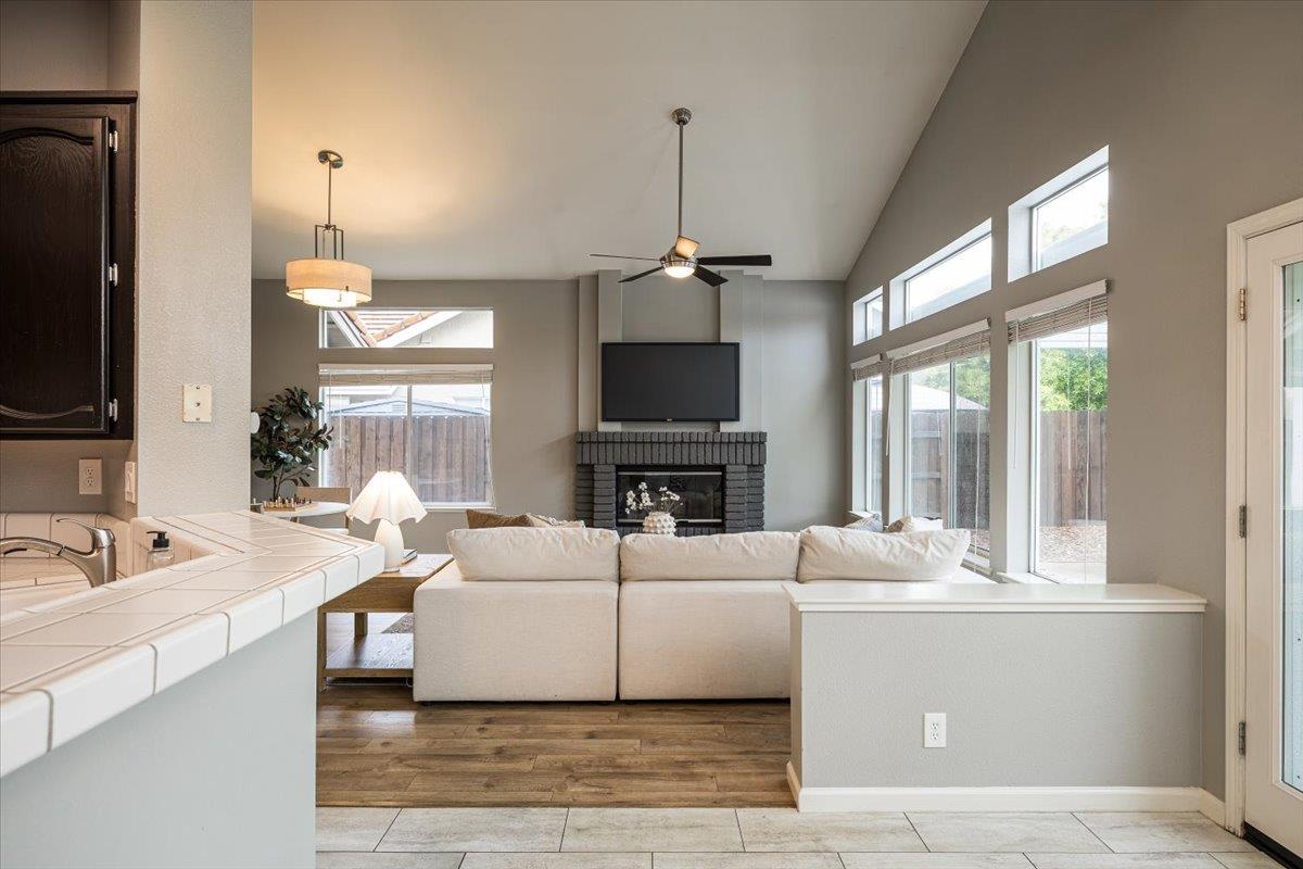 114 Kerwin Way Folsom, CA 95630 - Photo 14 of 29 a living room with furniture a fireplace and a flat screen tv