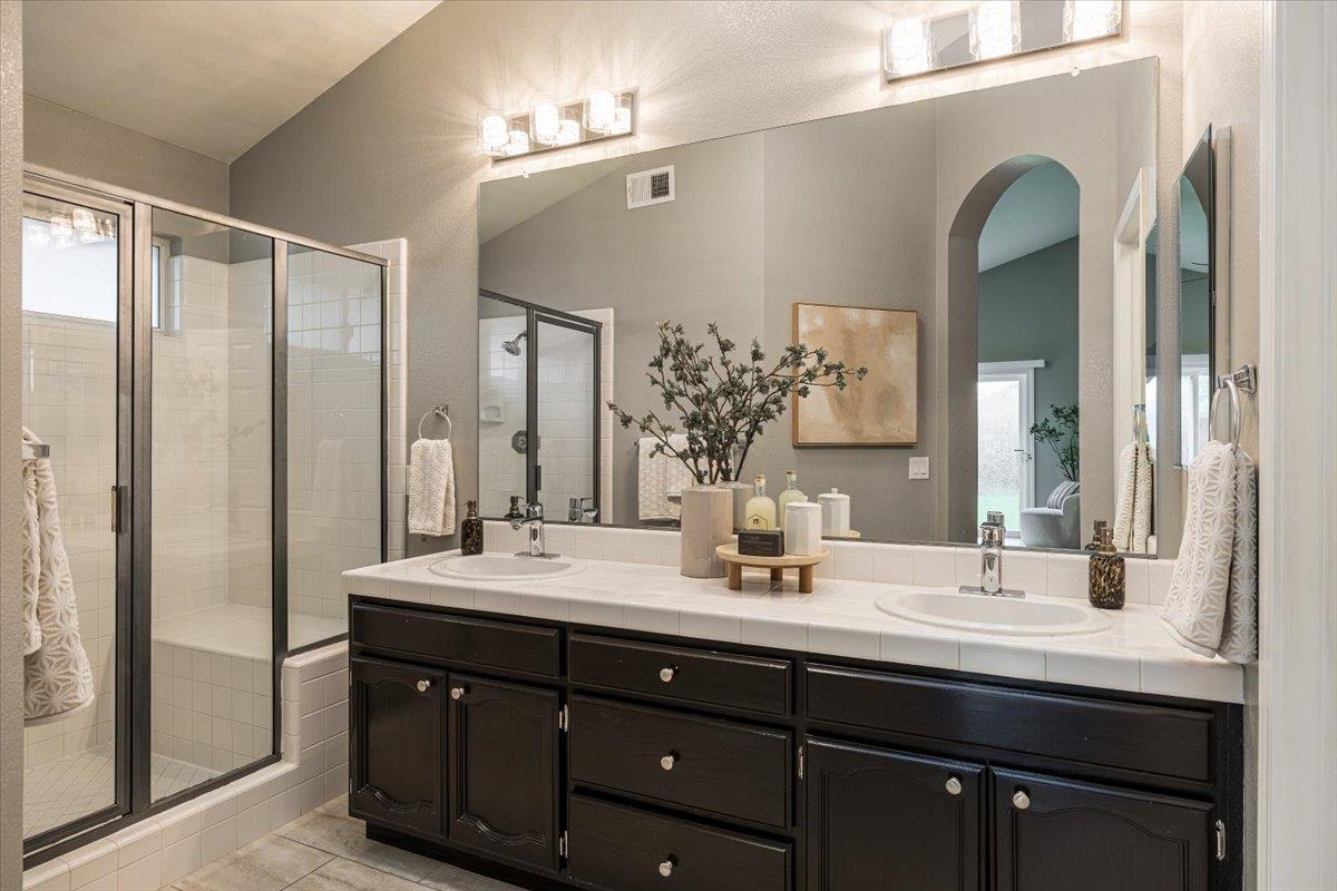 114 Kerwin Way Folsom, CA 95630 - Photo 18 of 29 a bathroom with a double vanity sink and a mirror