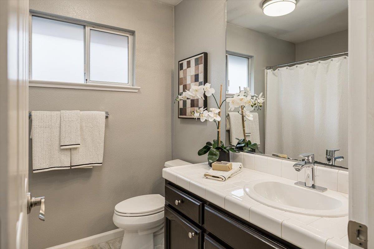 114 Kerwin Way Folsom, CA 95630 - Photo 24 of 29 a bathroom with a granite countertop sink toilet and mirror