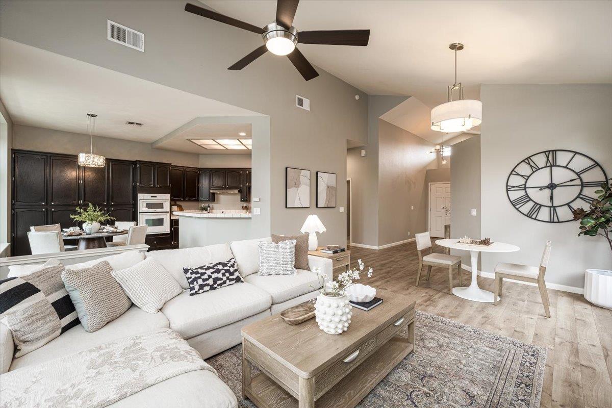 114 Kerwin Way Folsom, CA 95630 - Photo 8 of 29 a living room with furniture kitchen view and a chandelier