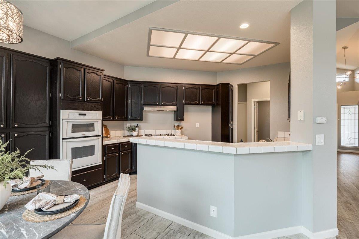 114 Kerwin Way Folsom, CA 95630 - Photo 10 of 29 a kitchen with kitchen island granite countertop stainless steel appliances a stove sink microwave and cabinets