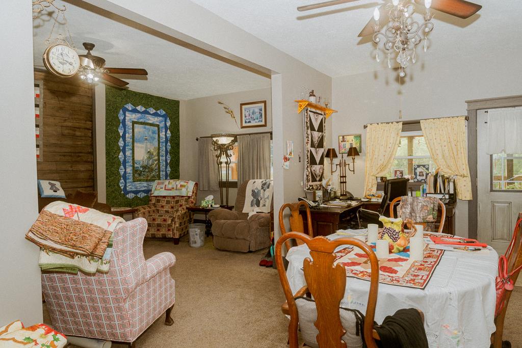 607 Main Street Emlenton, PA 16373 - Photo 16 of 62 a living room with furniture and a chandelier