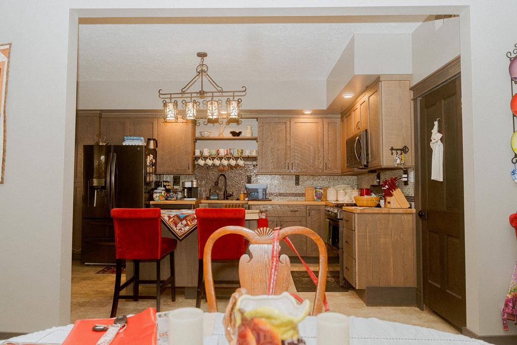 607 Main Street Emlenton, PA 16373 - Photo 18 of 62 a kitchen with refrigerator a sink and chairs