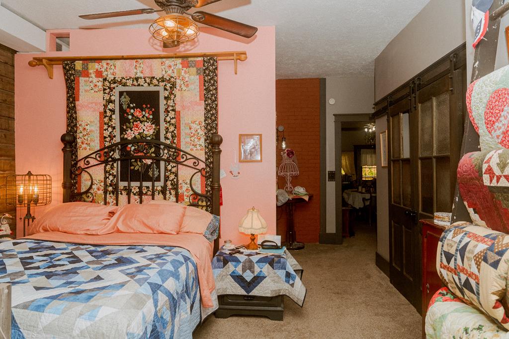607 Main Street Emlenton, PA 16373 - Photo 22 of 62 a bedroom with a bed and a chandelier