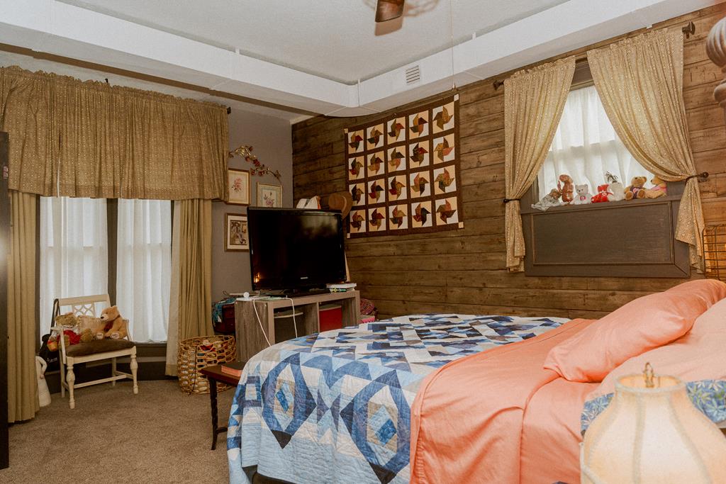 607 Main Street Emlenton, PA 16373 - Photo 23 of 62 a bedroom with a bed and a flat tv screen next to a window