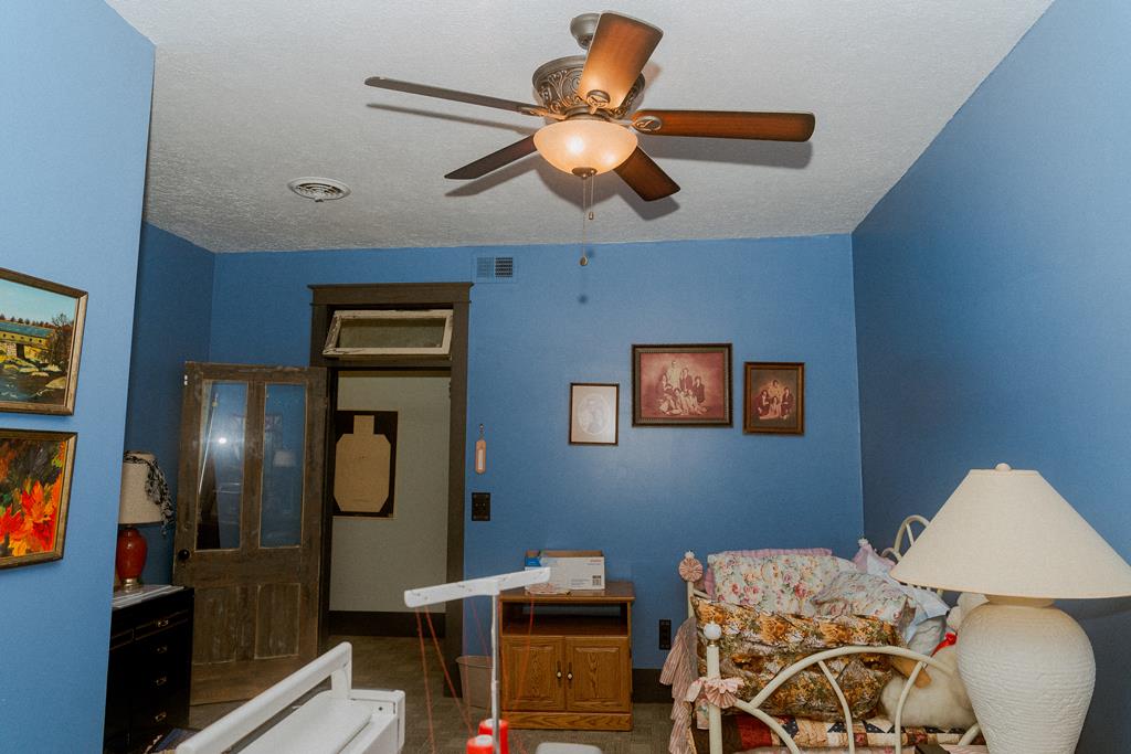 607 Main Street Emlenton, PA 16373 - Photo 30 of 62 a bedroom with a bed and a chandelier