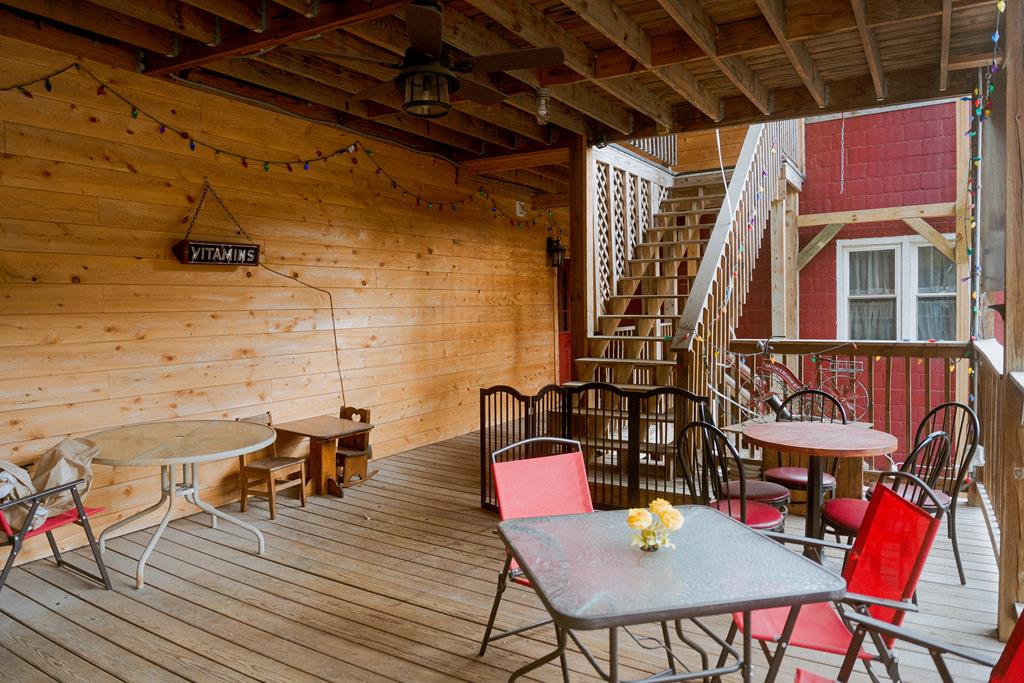 607 Main Street Emlenton, PA 16373 - Photo 55 of 62 a view of a roof deck with table and chairs with wooden floor