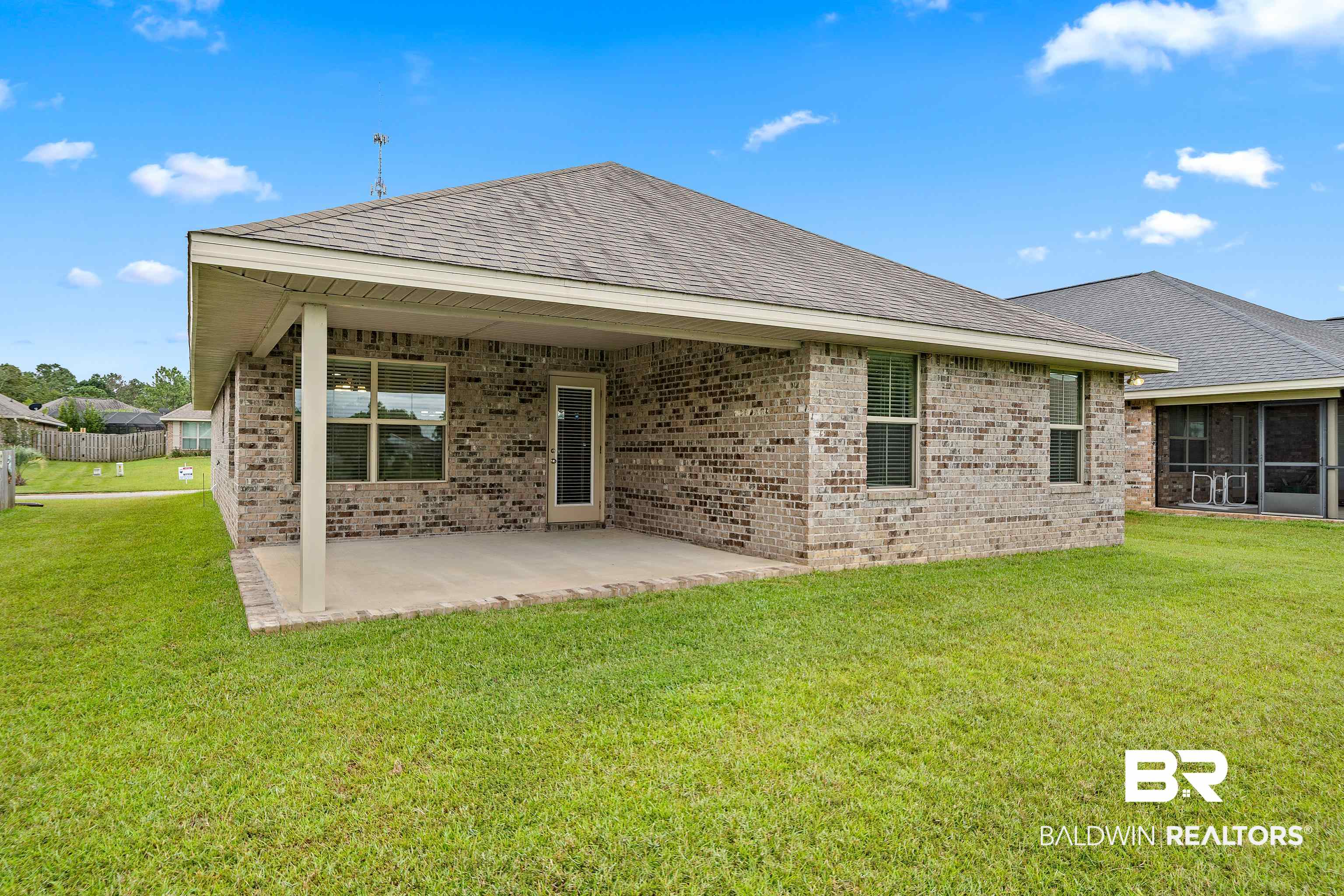 22631 Lake South Drive Foley, AL 36535 - Photo 24 of 25 Rear view of house featuring a yard and a patio area