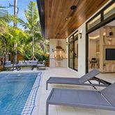 a swimming pool with outdoor seating and yard