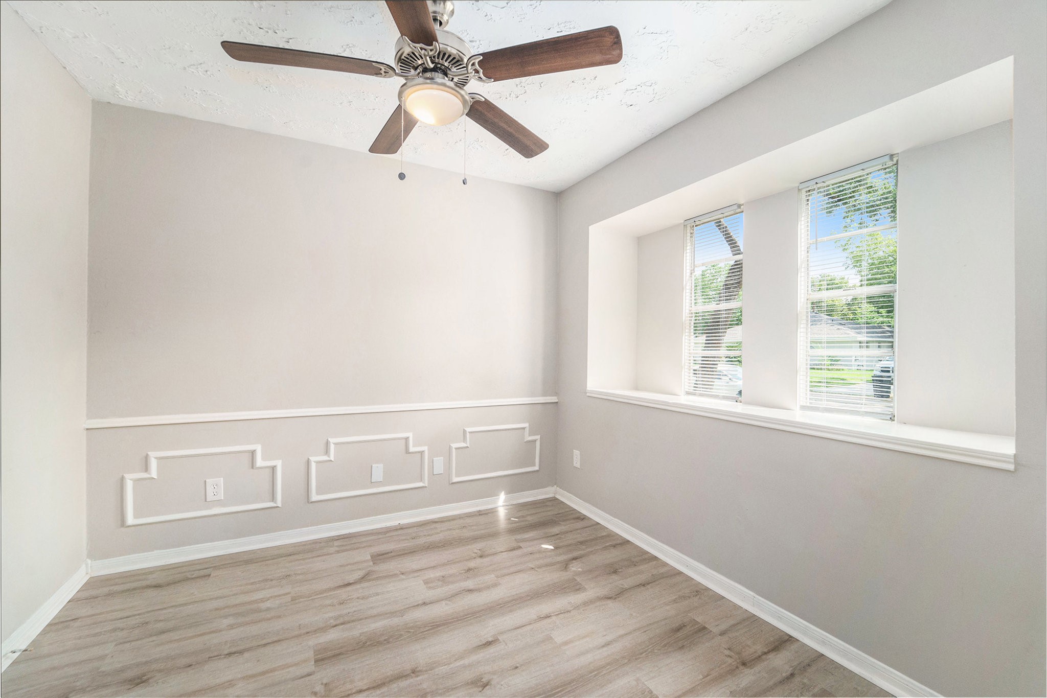 23235 Earlmist Drive Spring, TX 77373 - Photo 11 of 33 an empty room with wooden floor fan and windows