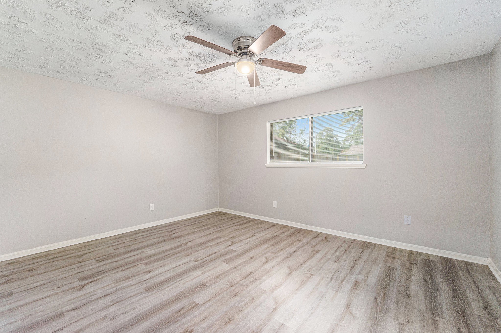 23235 Earlmist Drive Spring, TX 77373 - Photo 13 of 33 wooden floor in an empty room with a window