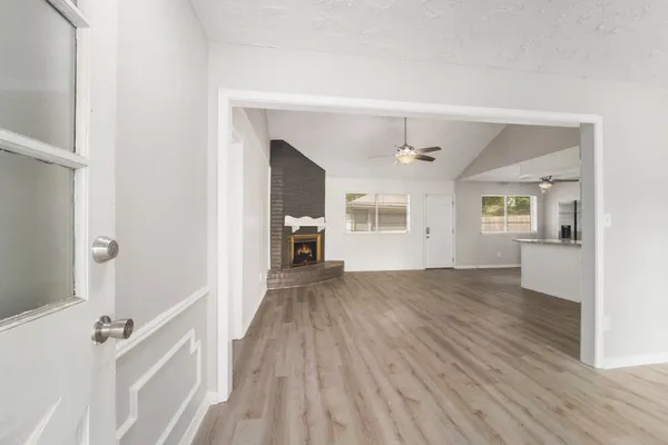 wooden floor in an empty room with a window