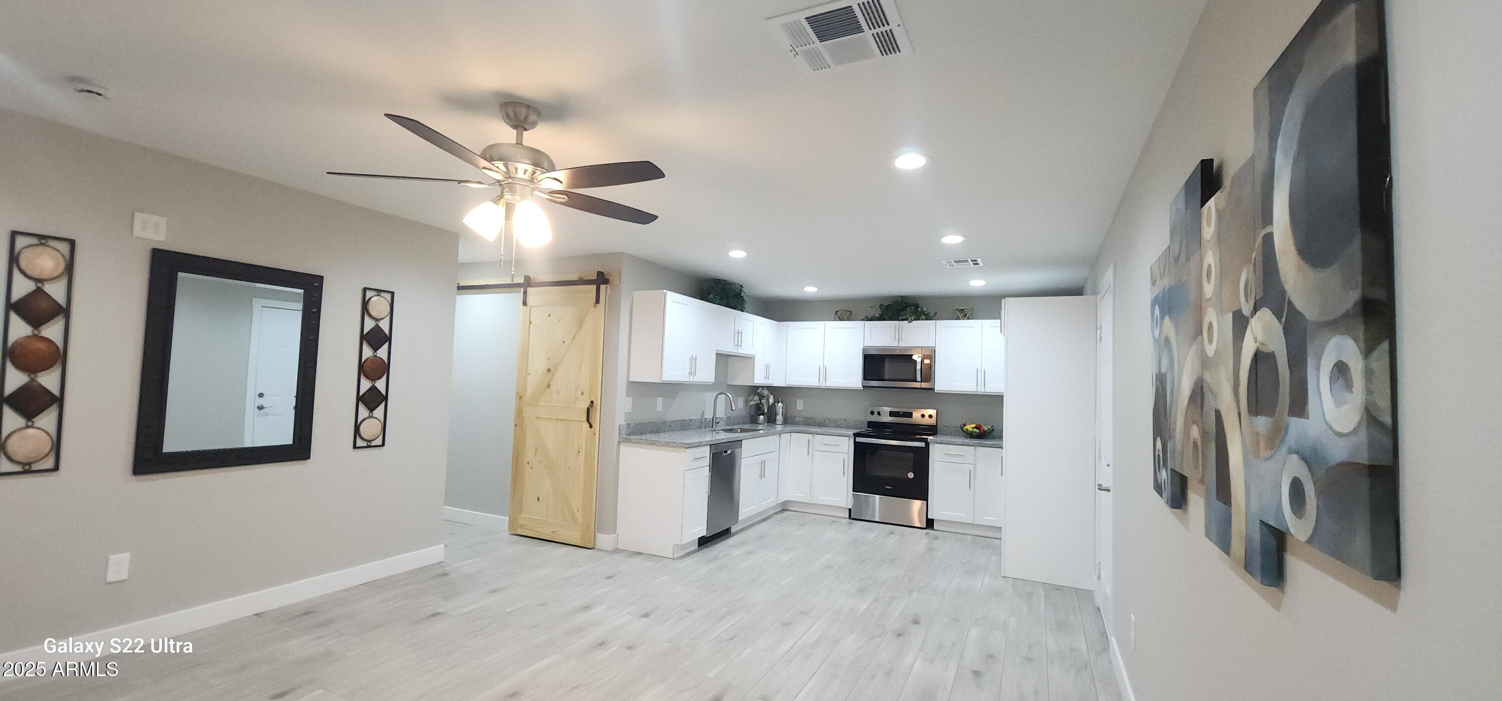 329 Fairhaven Road Kearny, AZ 85137 - Photo 3 of 11 a view of a kitchen with refrigerator and a stove top oven