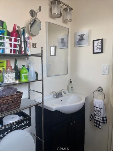 a bathroom with a black and white checkered floor