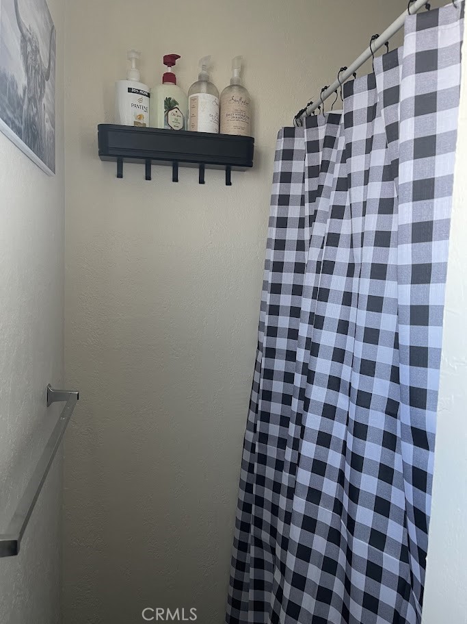 4675 Kickapoo Trail Landers, CA 92285 - Photo 10 of 14 a bathroom with a black and white checkered floor