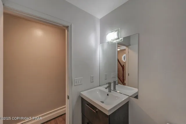 a living room with furniture a window and wooden floor