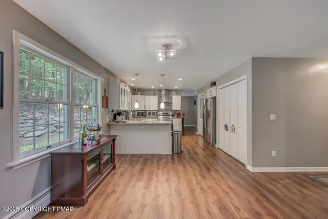 a kitchen with stainless steel appliances granite countertop a refrigerator sink and stove