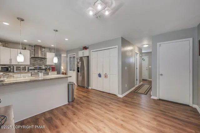 a view of a livingroom with furniture and hardwood floor