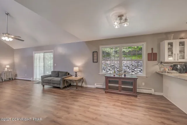 a view of a livingroom with furniture and a ceiling fan