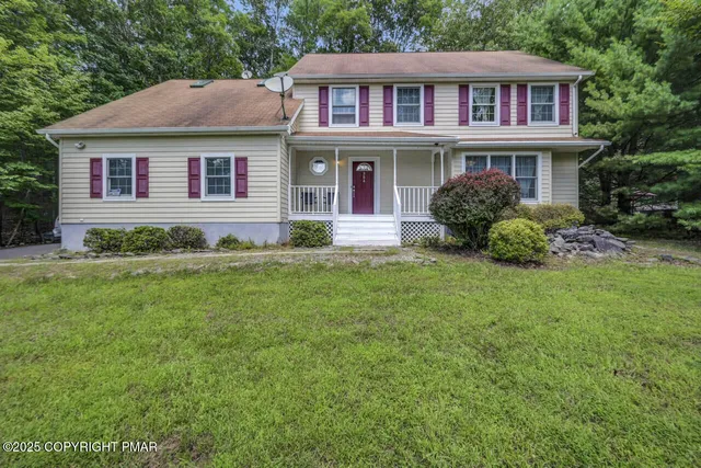 a view of a livingroom with furniture and a window