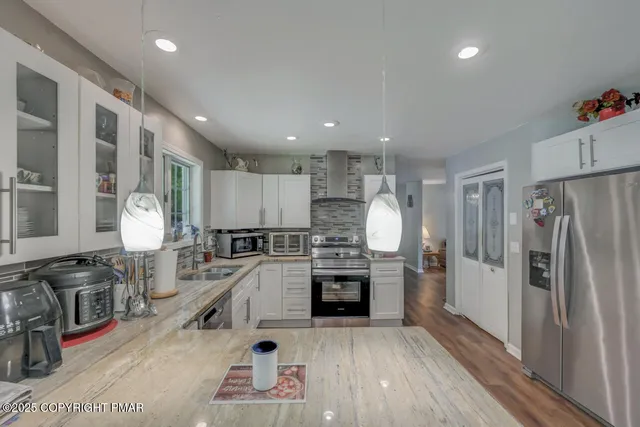 a view of a hallway to a livingroom and a chandelier