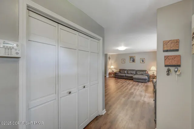 a living room with furniture and a wooden floor