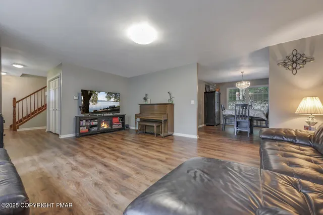 a view of a dining room with furniture and wooden floor