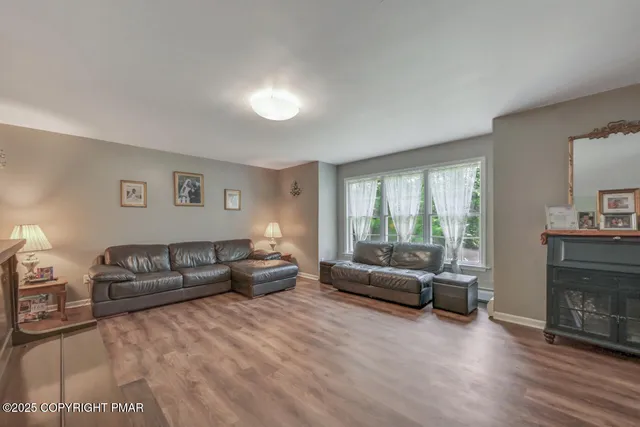 a view of a dining room with furniture and wooden floor