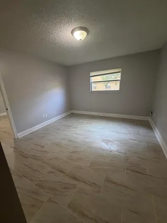 an empty room with a empty space and windows