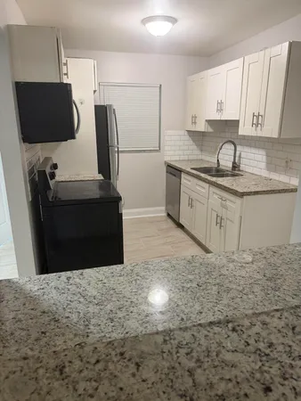 a kitchen with a sink and cabinets