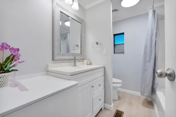 a bathroom with a sink toilet and a mirror