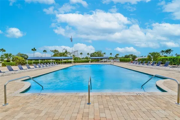 a view of a swimming pool and an outdoor seating
