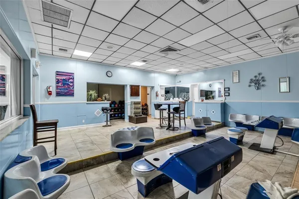 a living room with furniture a rug and kitchen view