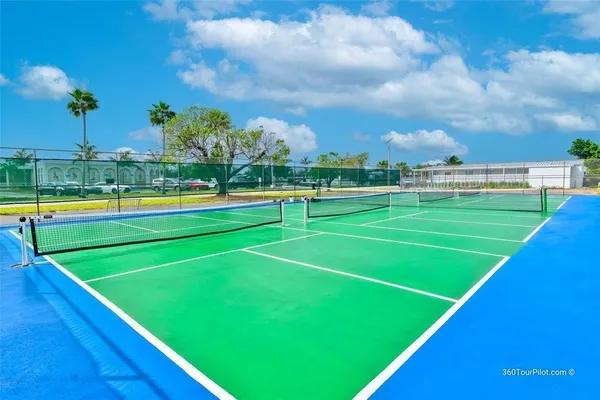 a view of an outdoor space and basketball court