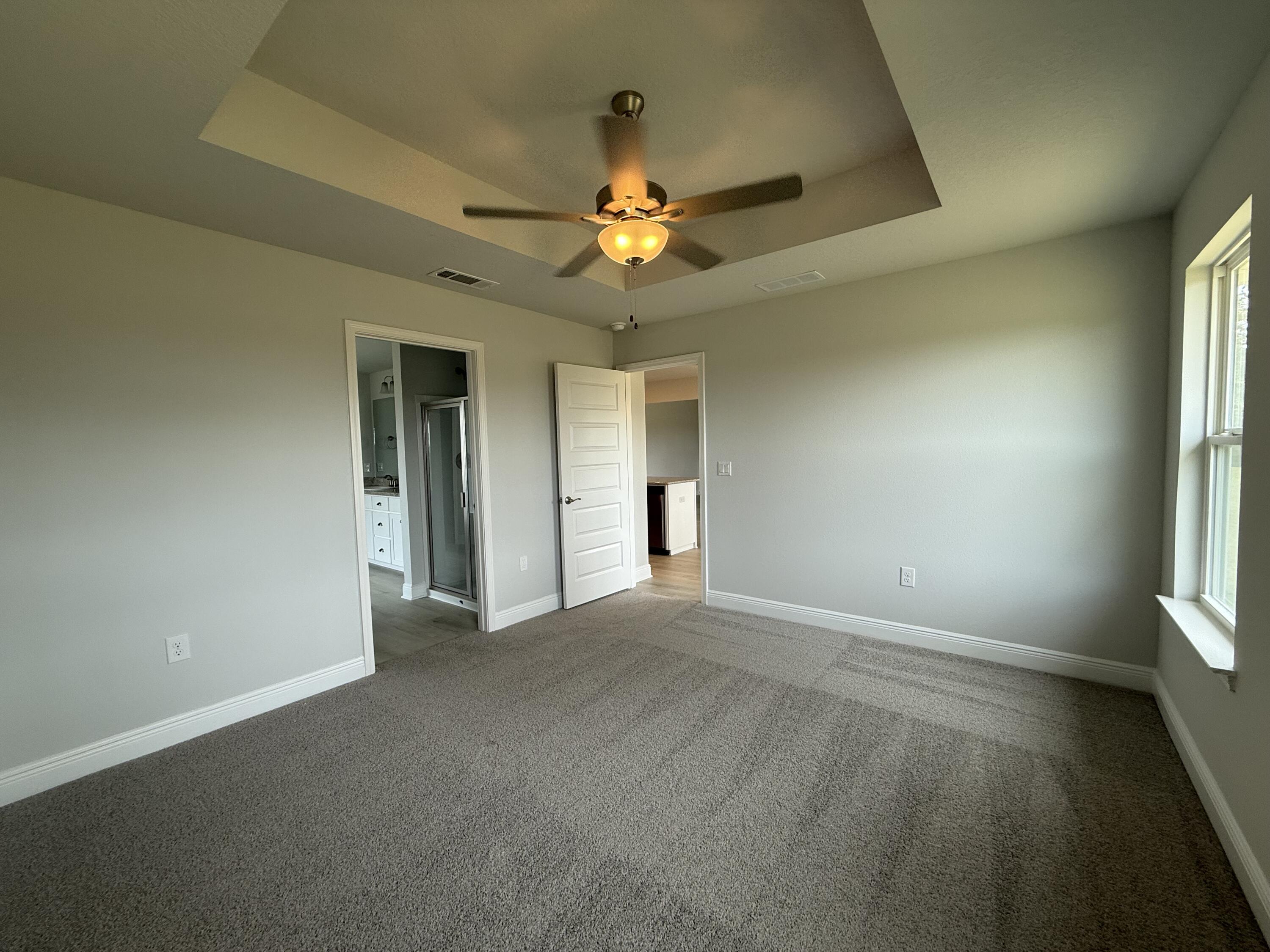 6002 Crocket Cove Crestview, FL 32539 - Photo 26 of 29 an empty room with windows and fan