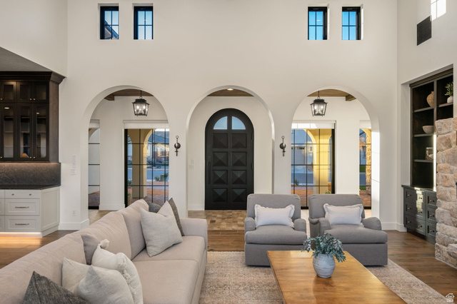 4871 South Homestead Way Washington, UT 84780 - Photo 16 of 151 Living area featuring arched walkways, wood finished floors, a high ceiling, french doors, and built in features