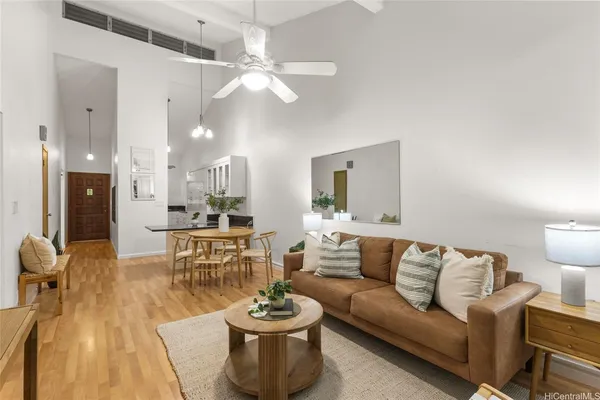 a living room with furniture and a chandelier
