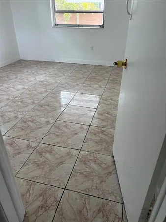 a kitchen with granite countertop a stove a microwave and a sink