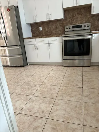 a view of a backyard with a kitchen