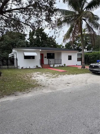 a view of a house with a yard and garage
