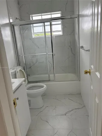 a bathroom with a toilet a sink and shower