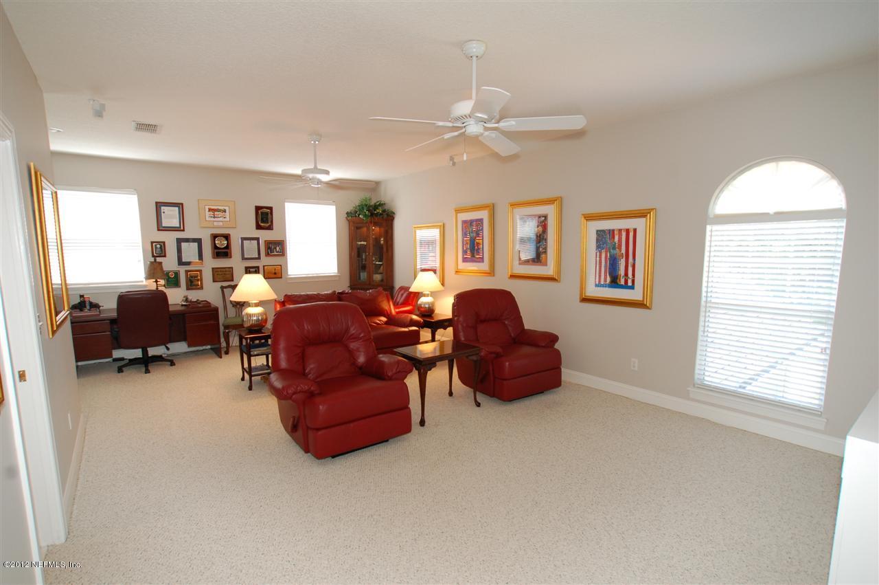 4665 Raggedy Point Road Fleming Island, FL 32003 - Photo 15 of 85 a living room with furniture a ceiling fan and a window