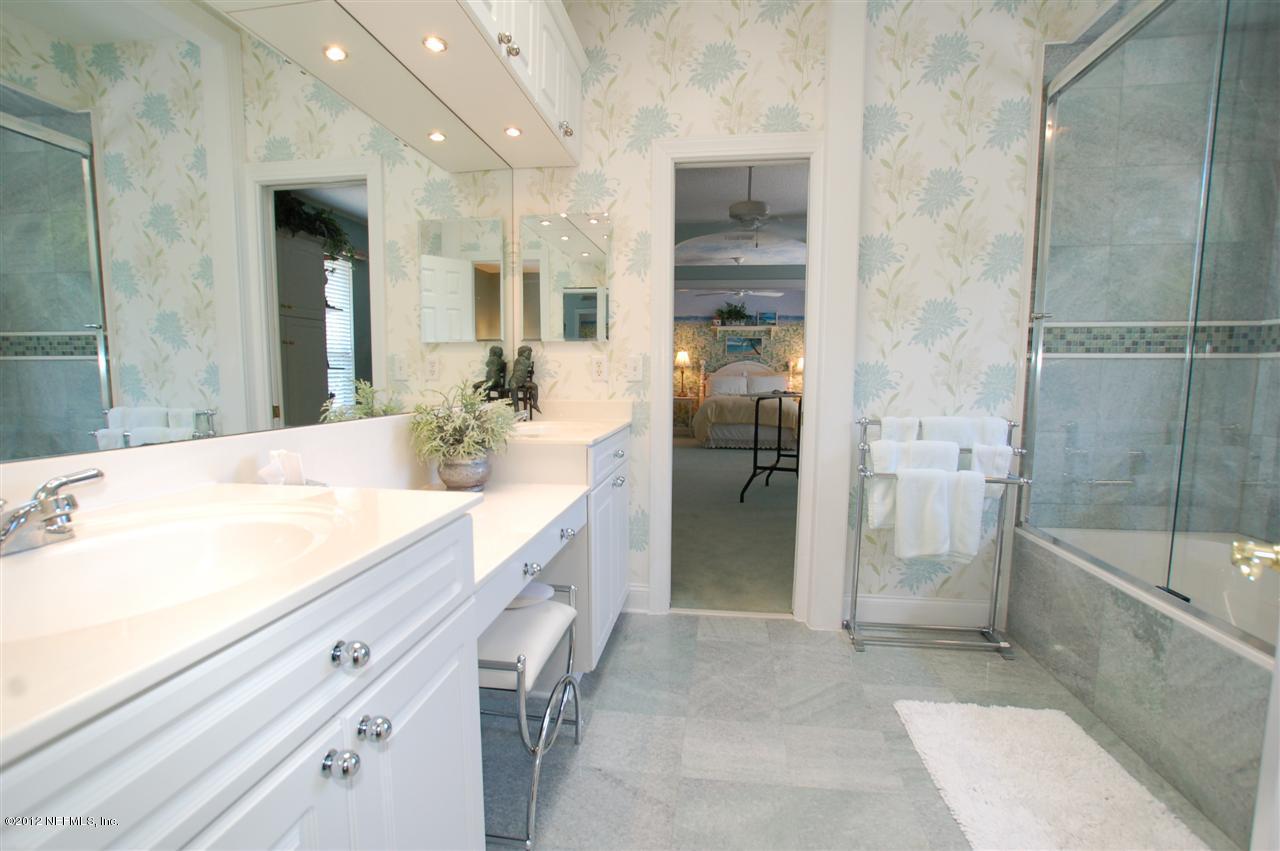 4665 Raggedy Point Road Fleming Island, FL 32003 - Photo 18 of 85 a spacious bathroom with a granite countertop sink mirror and shower
