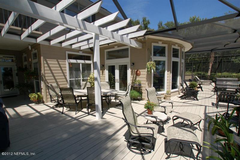 4665 Raggedy Point Road Fleming Island, FL 32003 - Photo 22 of 85 a view of a patio with table and chairs near a barbeque