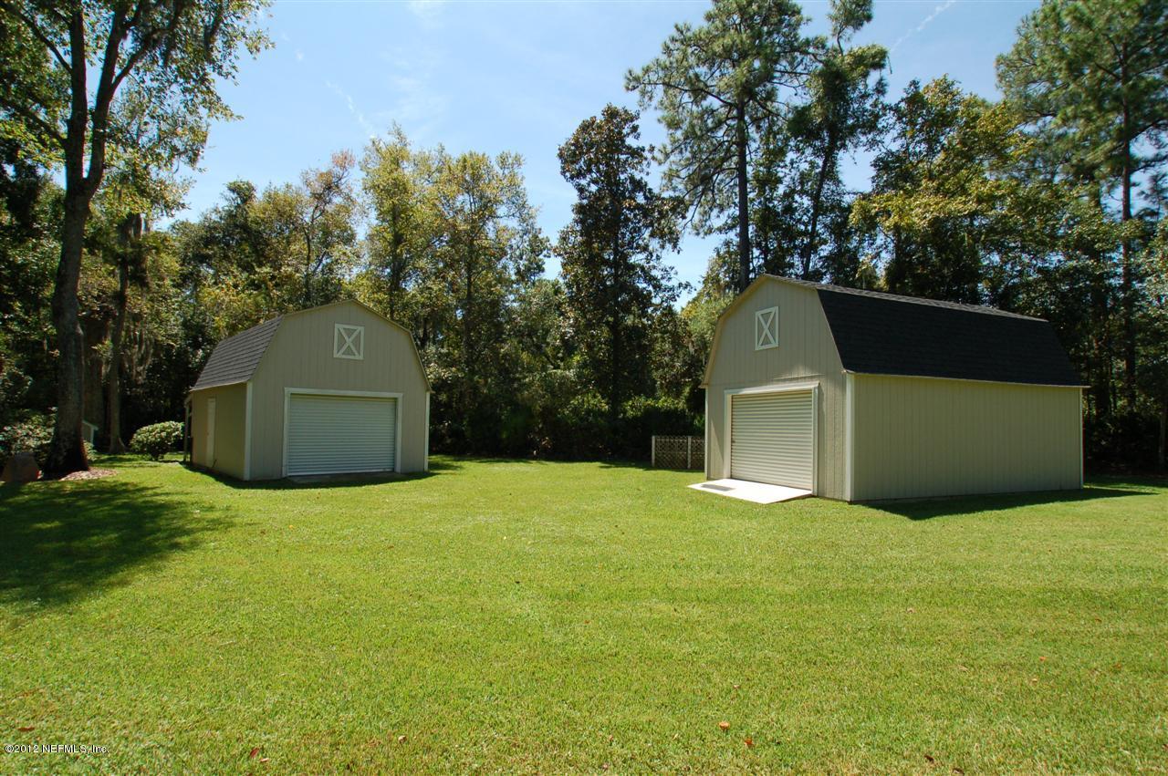 4665 Raggedy Point Road Fleming Island, FL 32003 - Photo 29 of 85 a front view of a house with a yard and trees