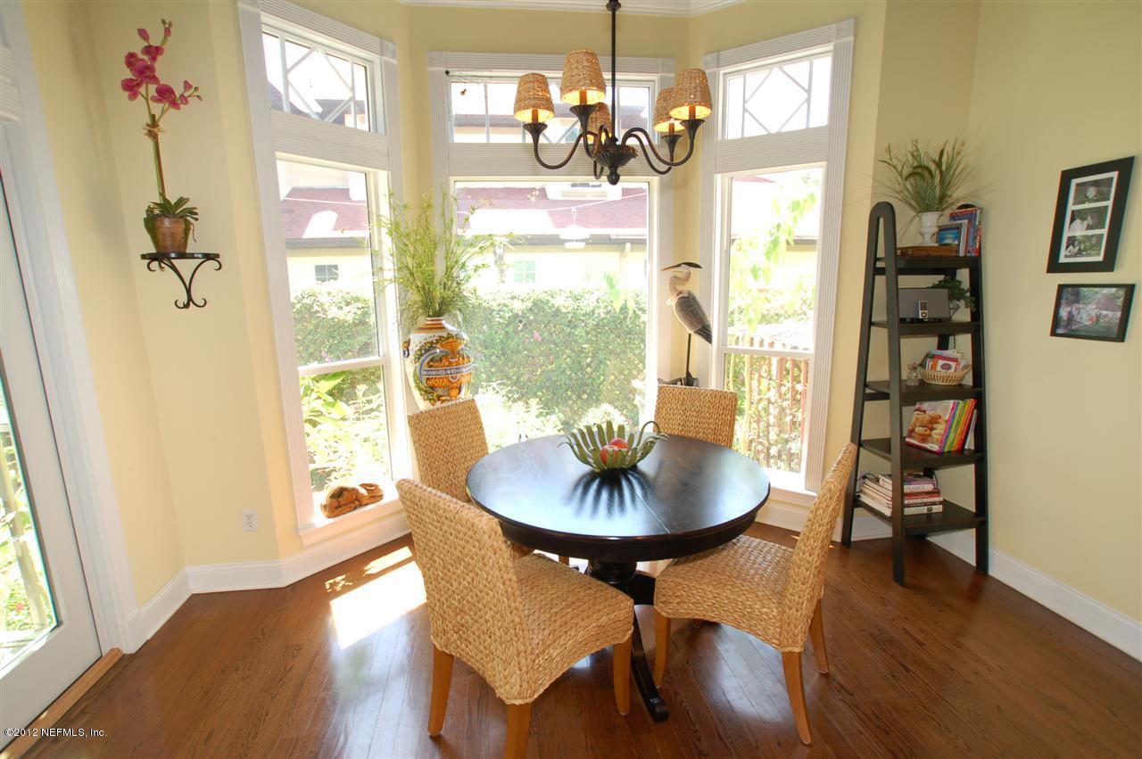 4665 Raggedy Point Road Fleming Island, FL 32003 - Photo 34 of 85 a dining room with furniture a chandelier and wooden floor