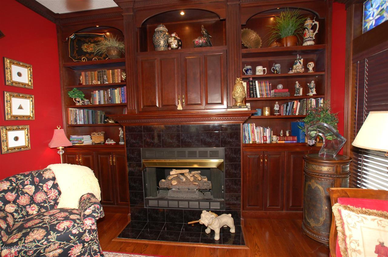 4665 Raggedy Point Road Fleming Island, FL 32003 - Photo 37 of 85 a living room with fireplace furniture and a fireplace